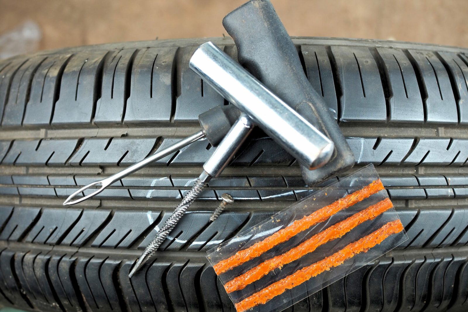 Rope plugs, a reamer and a screw on a tyre. An outside rope plug is not a finished repair.
